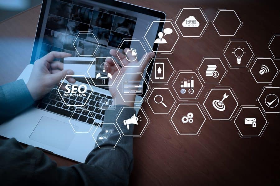 Image with hexagons in white colour with a laptop in the background.